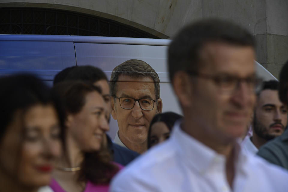 Supporters gather next to Popular Party candidate Nunez Feijoo, during a campaign rally in Vitoria, northern Spain, Saturday, July 15, 2023. The conservative Popular Party candidate for Sunday's general election is mostly unknown outside Spain, but he has been the country's most solid regional leader so far this century and has never lost an election. (AP Photo/Alvaro Barrientos)