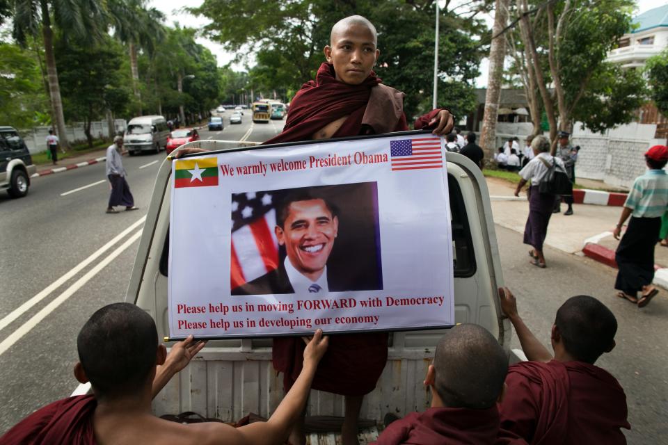 YANGON, MYANMAR - NOVEMBER 19: Burmese monks hold a poster showing US President Barack Obama during his arrival at Yangon International airport for his historical first visit to the country on November 19, 2012 in Yangon, Myanmar. Obama is the first US President to visit Myanmar while on a four-day tour of Southeast Asia that also includes Thailand and Cambodia. (Photo by Paula Bronstein/Getty Images)