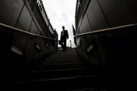 A man walks down steps into Bank tube station in the City of London, in this July 23, 2010 file photo. REUTERS/Andrew Winning/Files