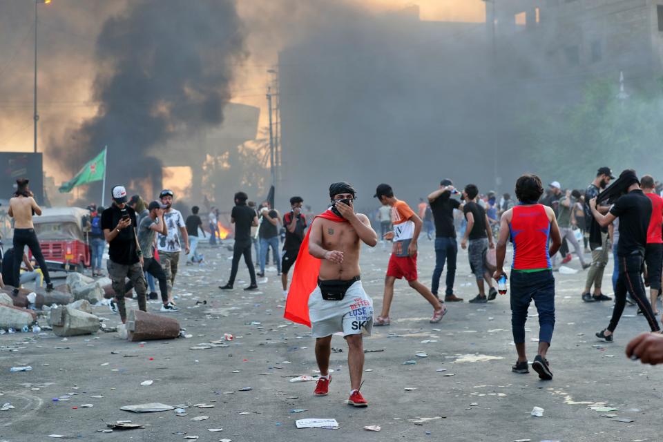 Anti-government protesters set fires and close a street during a demonstration in Baghdad, Iraq, Thursday, Oct. 3, 2019. Iraqi security forces fired live bullets into the air and used tear gas against a few hundred protesters in central Baghdad on Thursday, hours after a curfew was announced in the Iraqi capital on the heels of two days of deadly violence that gripped the country amid anti-government protests that killed over 19 people in two days. (AP Photo/Hadi Mizban)