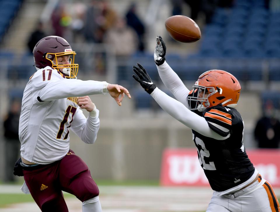 South Range quarterback Billy Skripac passes under pressure from Ironton's Aiden Layne in the first quarter of the OHSAA Division V State Championship football game at Tom Benson Hall of Fame Stadium.  Friday, December 02, 2022.