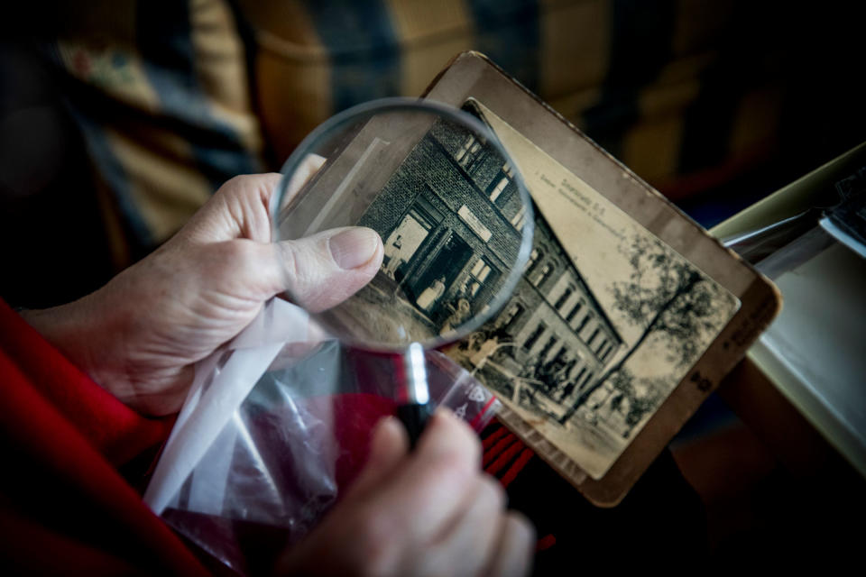 Hania Rosenberg, a Holocaust survivor, looks at photos of property her family owned in Poland before the war, at home in Stockholm, Aug. 5, 2017.<span class="copyright">Caspar Hedberg—The New York Times/Redux</span>