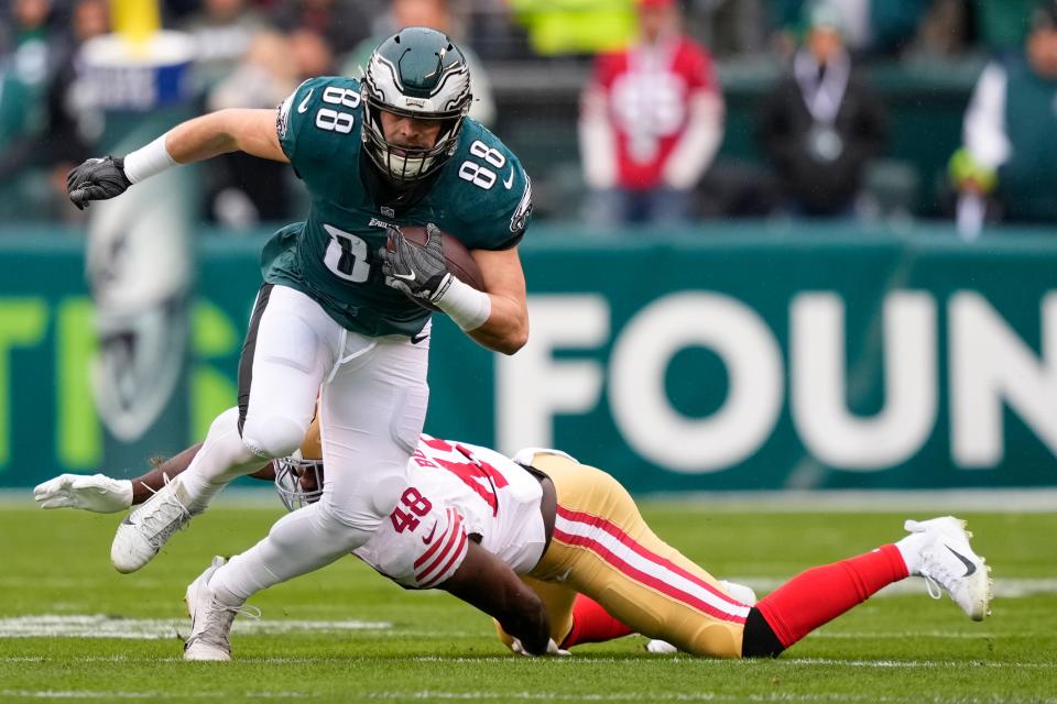 Philadelphia Eagles tight end Dallas Goedert (88) runs with the ball as San Francisco 49ers linebacker Oren Burks (48) tries to stop him during the first half of the NFC Championship NFL football game between the Philadelphia Eagles and the San Francisco 49ers on Sunday, Jan. 29, 2023, in Philadelphia.