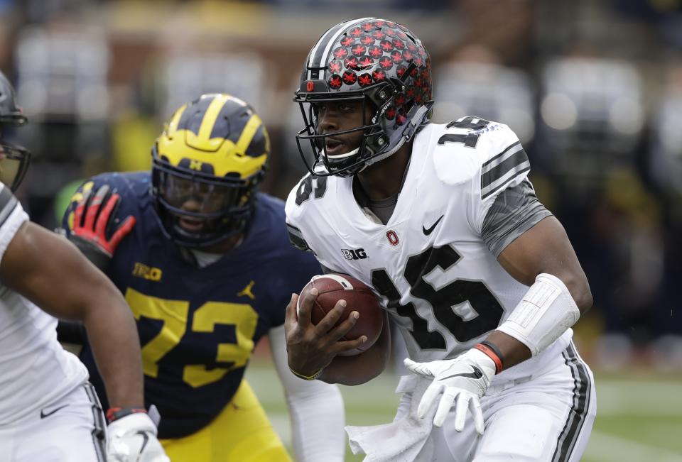 Ohio State quarterback J.T. Barrett (16) rushes during the first half of an NCAA college football game against Michigan, Saturday, Nov. 25, 2017, in Ann Arbor, Mich. (AP Photo/Carlos Osorio)