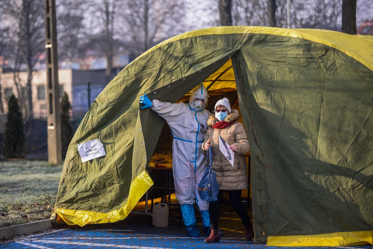 A health worker wears a protective suit, mask and gloves as he calls teachers to perform COVID-19 tests at the Special School Complex No. 6 on Jan. 11, 2021, in Krakow, Poland. The country plans to reopen primary schools on January 18, although the decision has yet to be made final. Possibly today, the ruling government will announce a possible prolongation of the ongoing restrictive measures to tackle the spread of coronavirus. Poland is now passing through the second wave of COVID-19 infections and has registered more than 1,390,000 infections and a death toll above 31,000.