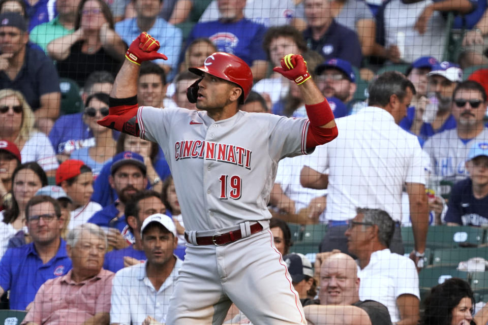 Cincinnati Reds' Joey Votto (19) gestures as he goes back to the dugout after hitting a home run against the Chicago Cubs during the first inning of a baseball game Tuesday, July 27, 2021, in Chicago. (AP Photo/David Banks)