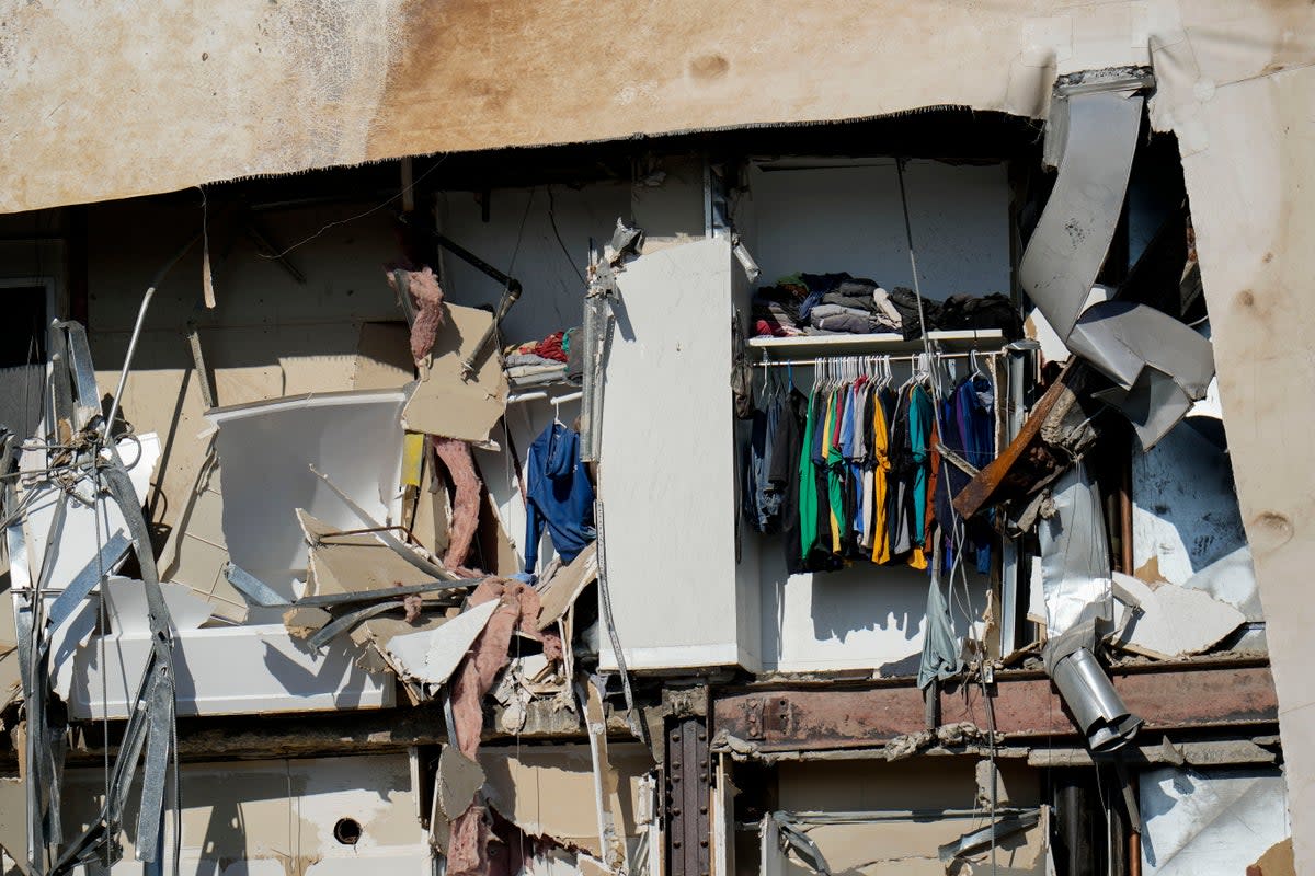 Clothing hanging in an apartment building that partially collapsed on Sunday afternoon can be seen Tuesday, May 30 (Copyright 2023 The Associated Press. All rights reserved.)