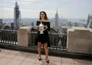 Bianca Andreescu, of Canada, poses with the US Open women's singles championship trophy at Top of the Rock, Sunday, Sept. 8, 2019, in New York. Andreescu defeated Serena Williams, of the United States, in the women's singles final of the U.S. Open tennis championships. (AP Photo/Charles Krupa)