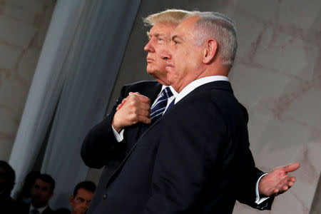 FILE PHOTO: U.S. President Donald Trump (L) embraces Israel's Prime Minister Benjamin Netanyahu after his remarks at the Israel Museum in Jerusalem May 23, 2017. REUTERS/Jonathan Ernst/File Photo