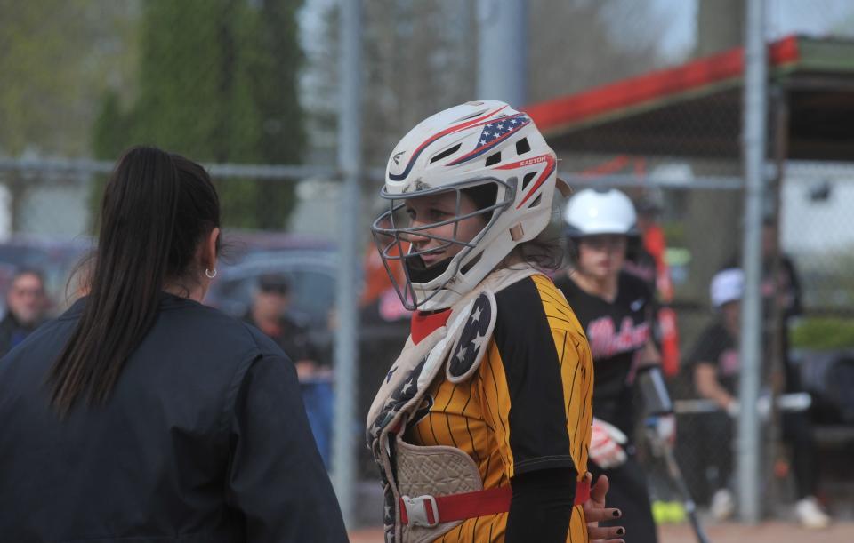 Colonel Crawford's Nettie Gallant talks with coach Sarah Fraser between innings.