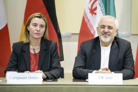 European Union High Representative Federica Mogherini (L) and Iranian Foreign Minister Javad Zarif wait for a meeting with officials from P5+1, the European Union and Iran at the Beau Rivage Palace Hotel in Lausanne March 31, 2015. REUTERS/Brendan Smialowski/Pool