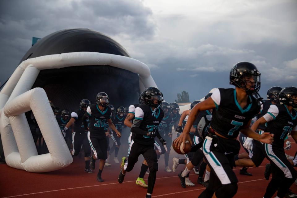 The Organ Mountain football team storms the field during Organ Mountain's football game against Albuquerque at the Field of Dreams on Friday, Aug. 19, 2022. Albuquerque High defeated Organ Mountain 22-20.