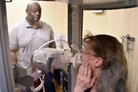 Respiratory therapist Vernon Johnson, left, conducts a pulmonary test on Christine Ekstedt at the Center for Asbestos Related Disease, Thursday, April 4, 2024, in Libby, Mont. The clinic has diagnosed thousands of people with asbestos-related disease following contamination from a nearby mine for vermiculite, a product that was shipped across the U.S. by rail for use as insulation and other purposes. (AP Photo/Matthew Brown)