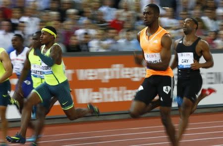 Michael Rogers (L-R) of the U.S., Kemar Bailey-Cole of Jamaica and Tyson Gay of the U.S. compete in the men's 100m A event of the Weltklasse Diamond League meeting at the Letzigrund stadium in Zurich August 28, 2014. REUTERS/Ruben Sprich