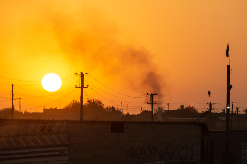 Smoke billows from a village on the Syrian side of the border on Oct. 9, 2019 in Akcakale, Turkey. (Photo: Burak Kara/Getty Images)