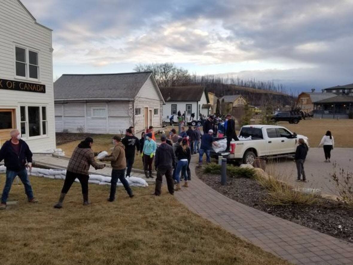 Volunteers sandbagging at the heritage village during the April 2020 flood.  (Fort McMurray Heritage Society/Facebook - image credit)