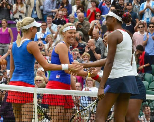 The Czech Republic's Andrea Hlavackova (left) and Lucie Hradecka shakes hands with Venus Williams (foreground) and Serena Williams after the Olympic women's doubles final