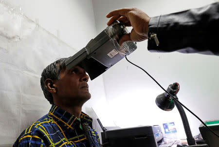 A man goes through the process of eye scanning for the Unique Identification (UID) database system, also known as Aadhaar, at a registration centre in New Delhi, India, January 17, 2018. Picture taken January 17, 2018. REUTERS/Saumya Khandelwal