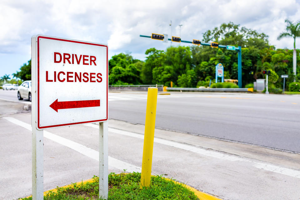 sign pointing to where to get a driver's license