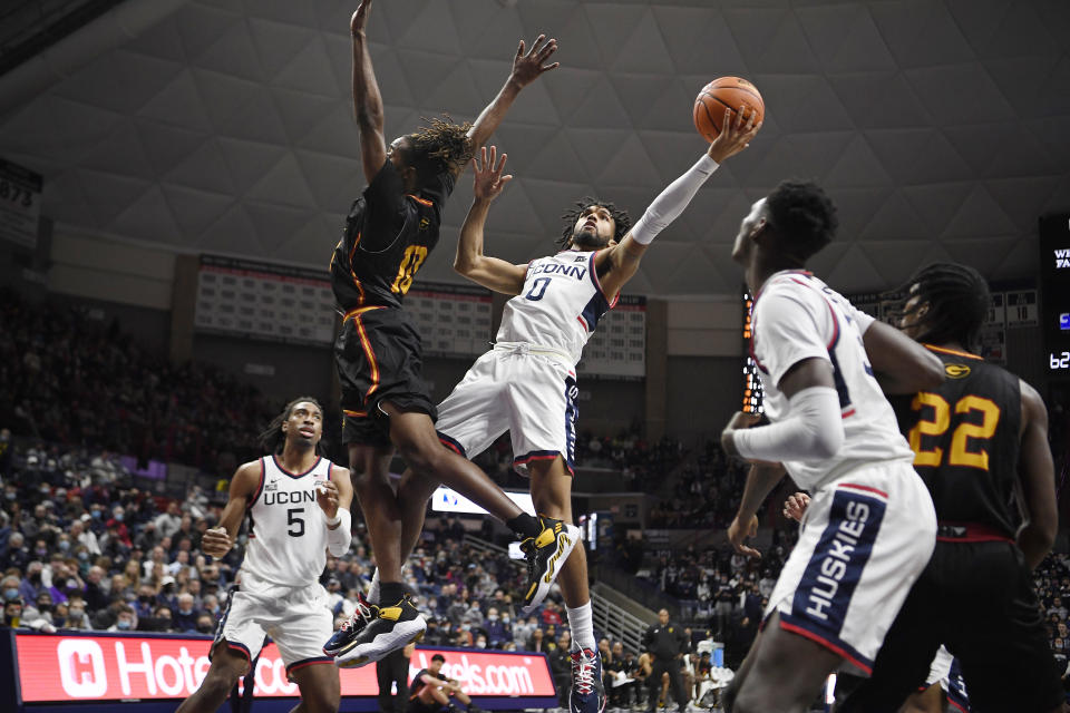 Connecticut's Jalen Gaffney shoots the ball as Grambling State's Shawndarius Cowart, left, defends, in the second half of an NCAA college basketball game, Saturday, Dec. 4, 2021, in Storrs, Conn. (AP Photo/Jessica Hill)