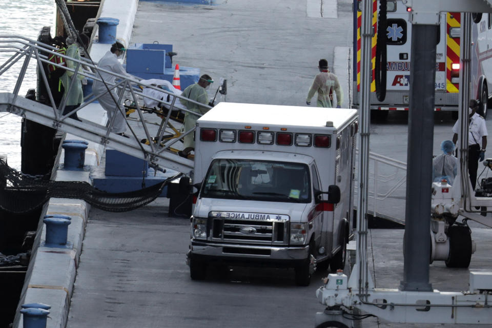 A person on a stretcher is removed from Carnival's Holland America cruise ship Zaandam at Port Everglades during the new coronavirus pandemic, Thursday, April 2, 2020, in Fort Lauderdale, Fla. Those passengers that are fit for travel in accordance with guidelines from the U.S. Centers for Disease Control will be permitted to disembark. (AP Photo/Lynne Sladky)