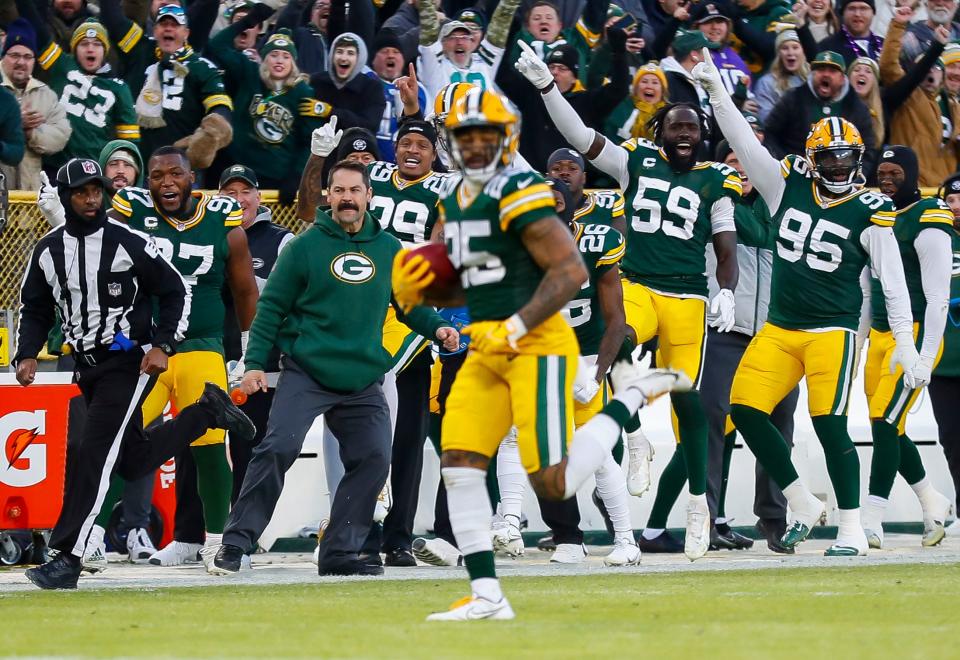 The Green Bay Packers bench celebrates as Keisean Nixon returns a kickoff for a touchdown against the Minnesota Vikings.