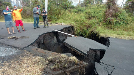 A crack in the road is seen in Pahoa, Hawaii, U.S., May 17, 2018 in this picture obtained from social media on May 18, 2018. KRIS BURMEISTER/via REUTERS