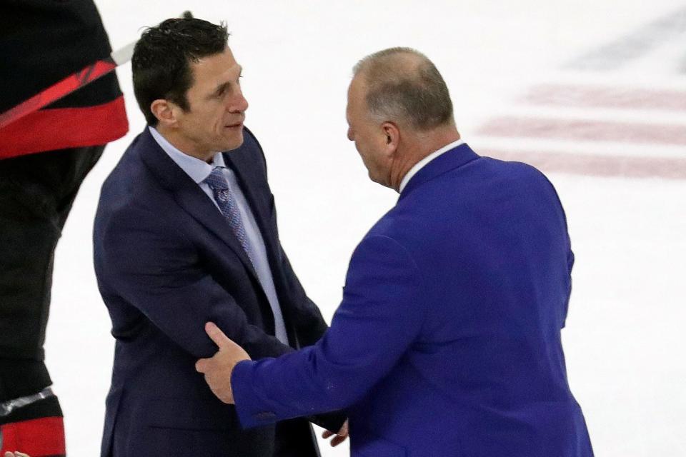 Carolina Hurricanes head coacxh Rod Brind'Amour, left, shakes hands with New York Rangers Gerard Gallant after the Rangers won Game 7 of an NHL hockey Stanley Cup second-round playoff series Monday, May 30, 2022, in Raleigh, N.C. (AP Photo/Chris Seward)