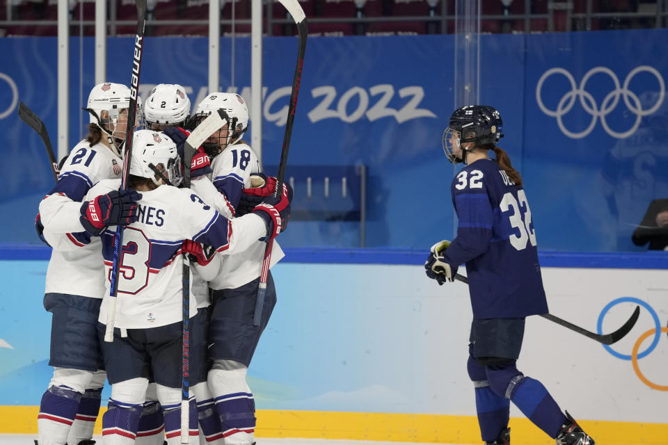 United States players celebrate a goal as Finland's Emilia Vesa (32) skates by during a preliminary round women's hockey game at the 2022 Winter Olympics, Thursday, Feb. 3, 2022, in Beijing. (AP Photo/Petr David Josek)