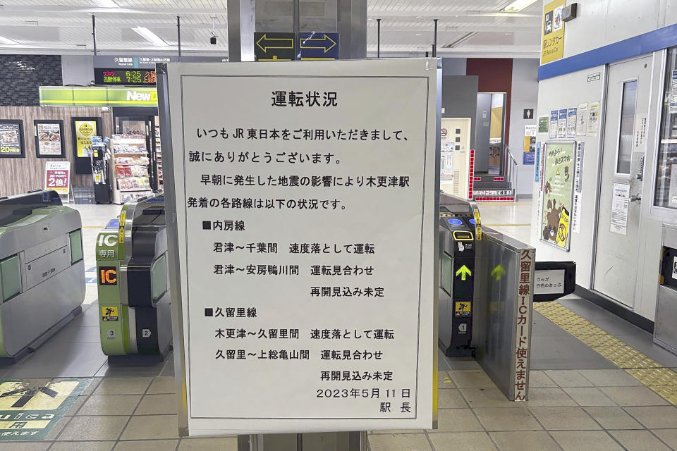 A notice about train services is placed at a station in Kisarazu, Chiba prefecture, near Tokyo Thursday, May 11, 2023. An earthquake shook Japan's capital, Tokyo, and surrounding areas on Thursday, injuring several people and causing minor damage, officials and media said. (Kyodo News via AP)