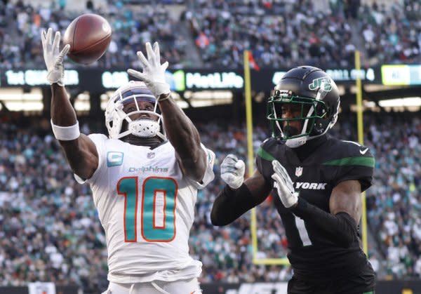 Miami Dolphins wide receiver Tyreek Hill (L) reaches for a catch against the New York Jets on Friday at MetLife Stadium in East Rutherford, N.J. Photo by John Angelillo/UPI