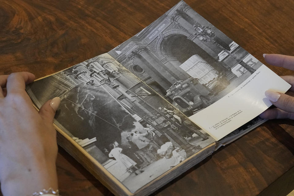 Anna Bottinelli, head of the Monuments Men and Women Foundation, looks at photos in a book by Rose Valland in Dallas, Monday, Dec. 11, 2023. With the foundation's help Valland's book will be the first English translation of a the Monuments Woman work. (AP Photo/LM Otero)