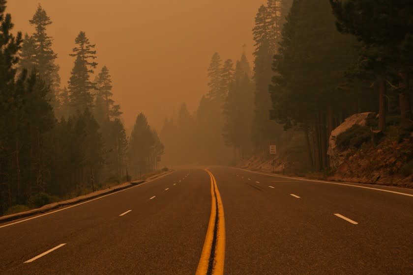 SOUTH LAKE TAHOE, CA - AUGUST 26: Hwy 50 remains closed due to the Caldor fire as smoke and ash fill the air in South Lake Tahoe as firefighters tackling the Caldor Fire now have priority over available resources as the blaze has become "the number one fire in the country right now in terms of priorities for values at risk." The fire is currently burning only 11 miles southwest of the Lake Tahoe area.on Thursday, Aug. 26, 2021 in South Lake Tahoe, CA. (Jason Armond / Los Angeles Times)