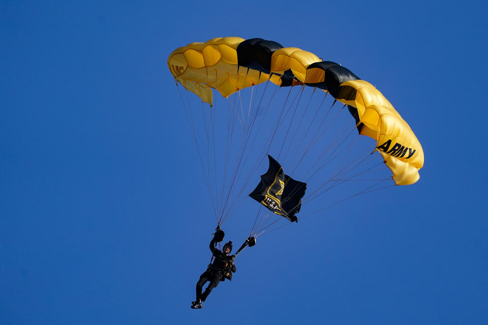 The U.S. Army Parachute Team the Golden Knights descend into National Park before a baseball game between the Washington Nationals and the Arizona Diamondbacks Wednesday, April 20, 2022, in Washington. The U.S. Capitol was briefly evacuated after police said they were tracking an aircraft “that poses a probable threat,” but the plane turned out to be the military aircraft with people parachuting out of it for a demonstration at the Nationals game, officials told The Associated Press. (AP Photo/Alex Brandon)