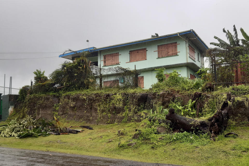 A house is shuttered in the preparation for cyclone Yasa in the Tamavua neighborhood of Suva, Fiji, Thursday, Dec. 17, 2020. Fiji was urging people near the coast to move to higher ground Thursday ahead of a nationwide curfew as the island nation prepared for a major cyclone to hit.(AP Photo/Aileen Torres-Bennett)