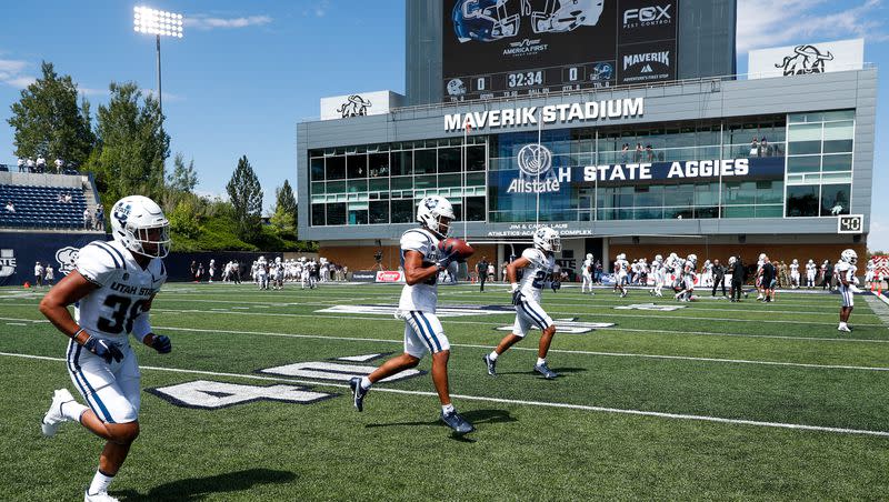 Utah State Aggies players warm up before playing the UConn Huskies at the Maverik Stadium in Logan on Saturday, Aug. 27, 2022. The Aggies host the high-octane Colorado State Rams Saturday night.