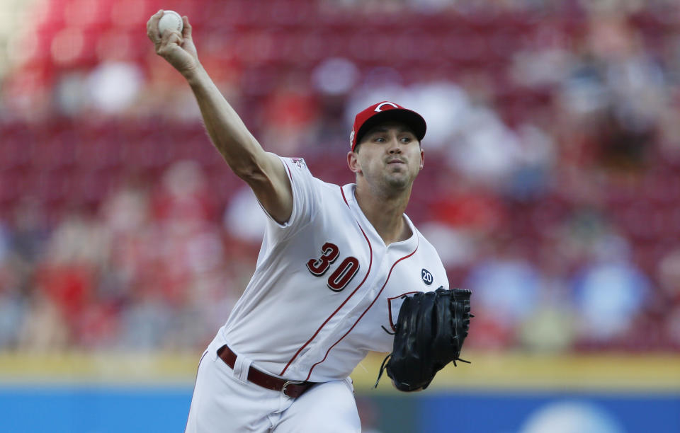 Cincinnati Reds starting pitcher Tyler Mahle (30) throws against the Milwaukee Brewers during the first inning of a baseball game, Monday, July 1, 2019, in Cincinnati. (AP Photo/Gary Landers)