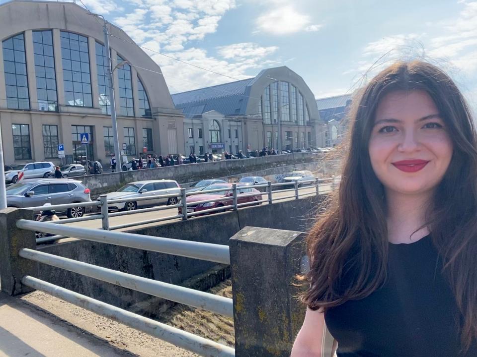 A woman in front of a building.