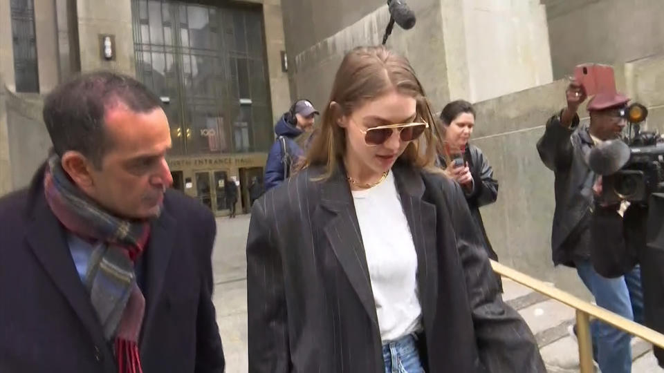 In this photo taken from video, super model Gigi Hadid walks out of a Manhattan court, Monday, Jan. 13, 2020, in New York. Hadid, who lives in Manhattan, turned heads Monday as part of the latest pool of 120 potential jurors summoned for Harvey Weinstein's rape trial. Hadid disclosed that she has met Weinstein and actress Salma Hayek, a potential witness, but said that she could remain impartial. She was asked to return Thursday for additional questioning. (AP Photo/Ted Shaffrey)
