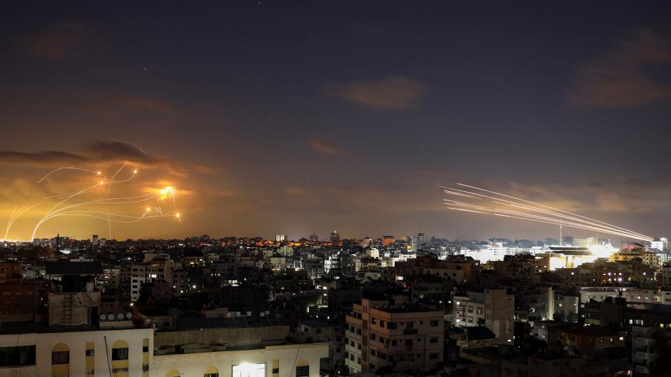 A photo of rockets being intercepted by other rockets in the night sky.