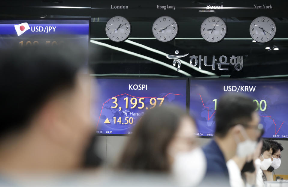 Currency traders watch computer monitors near the screens showing the Korea Composite Stock Price Index (KOSPI), center, and the foreign exchange rate between U.S. dollar and South Korean won, right, at the foreign exchange dealing room in Seoul, South Korea, Thursday, April 29, 2021. Asian shares rose Thursday and U.S. futures also were higher after President Joe Biden delivered a speech to Congress that outlined ambitious plans for jobs creating spending on early education, child care and other public services. (AP Photo/Lee Jin-man)