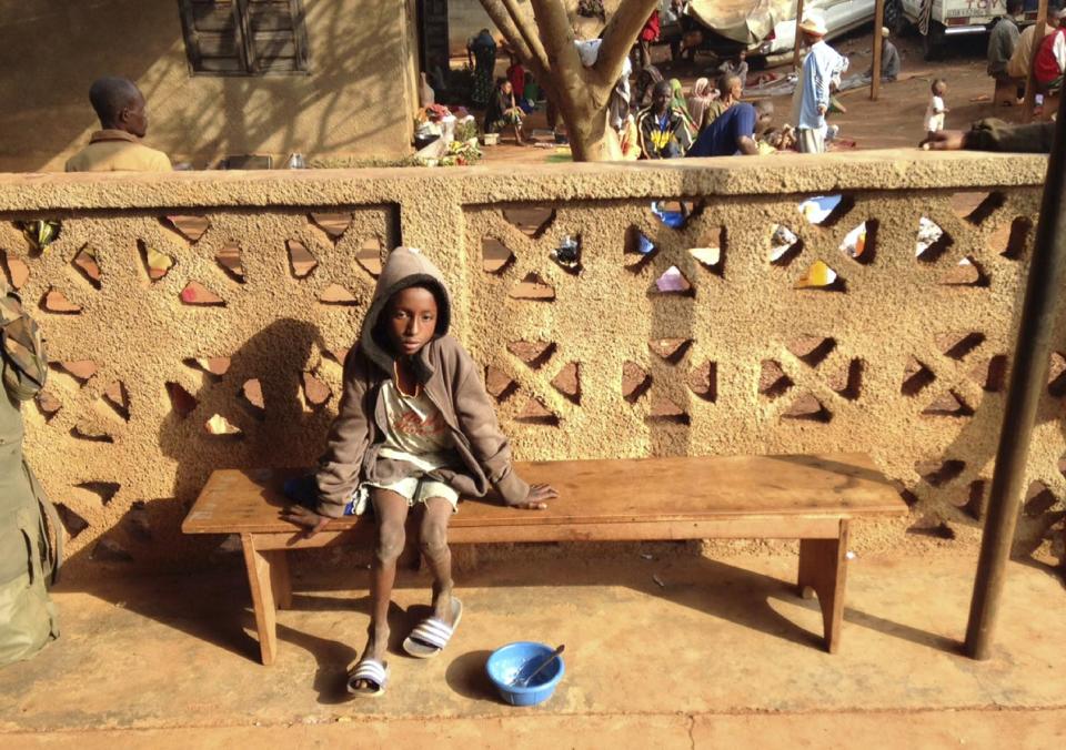 Ibrahim Adamou sits on a bench at a Catholic church in Carnot a town 200 kilometers (125 miles) from the Cameroonian border, in the Central African Republic Monday, Feb. 24, 2014. Ibrahim Adamou wasn’t sure whether any of his five siblings had survived the attack by Christian militiamen who opened fire on his family as the group of herders journeyed on foot. His parents already had been killed in front of him. (AP Photo/Krista Larson)