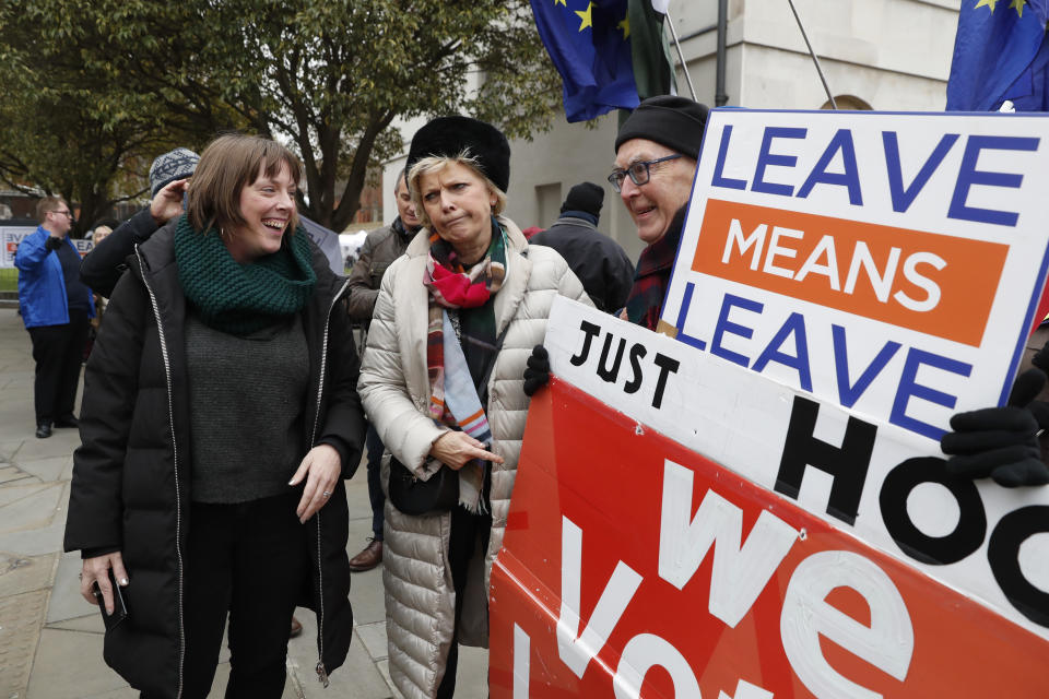 British conservative lawmaker Anna Soubry, centre, who campaigned to remain in the European Union during referendum debates, reacts with pro-Brexit protesters outside parliament in London, Thursday Jan. 10, 2019. Soubry was verbally confronted by Brexit campaigners on Monday outside parliament. Prime Minister Theresa May's proposed Brexit deal seems widely disliked by both pro-Europe and pro-Brexit politicians, threatening the exit agreement and future relations with EU. (AP Photo/Alastair Grant)