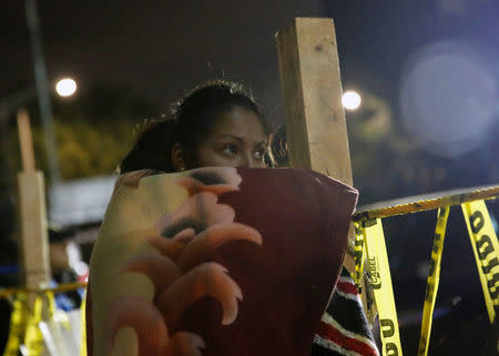 A woman waits for news of her loved ones, next to a collapsed building, after an earthquake in Mexico City, Mexico September 25, 2017. REUTERS/Henry Romero