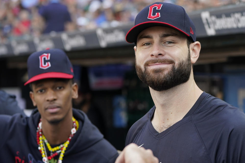 Cleveland Guardians pitcher Lucas Giolito, right, smiles in the dugout as pitcher Triston McKenzie looks on in the first inning of a baseball game against the Tampa Bay Rays, Sunday, Sept. 3, 2023, in Cleveland. (AP Photo/Sue Ogrocki)