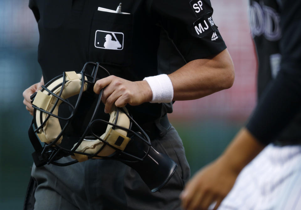 Major League Baseball umpires wore white wristbands Saturday as a form of protest. (AP Photo/David Zalubowski)