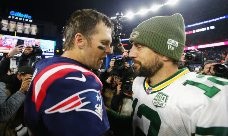 Tom Brady and Aaron Rodgers talk after a game.