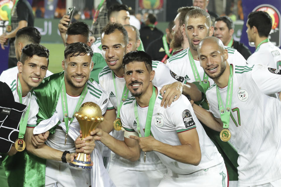 Algerian players celebrate after winning the African Cup of Nations final soccer match between Algeria and Senegal in Cairo International stadium in Cairo, Egypt, Friday, July 19, 2019. (AP Photo/Hassan Ammar)