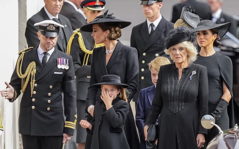 Kate, Princess of Wales, from left, Princess Charlotte, Prince George, Camilla, the Queen Consort, and Meghan, Duchess of Sussex, follow the coffin of the queen.