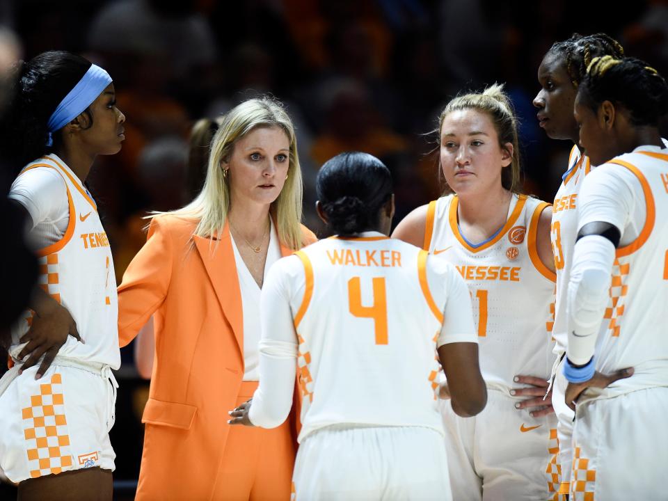 Tennessee coach Kellie Harper (left) gives out instructions during Thursday's game vs. UConn.